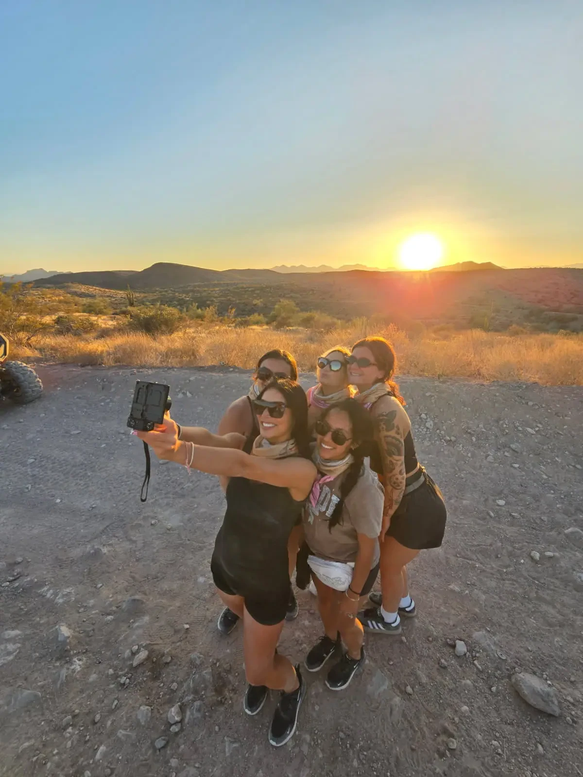 Group selfie at golden hour on a 360 Adventures sunset dune buggy tour
