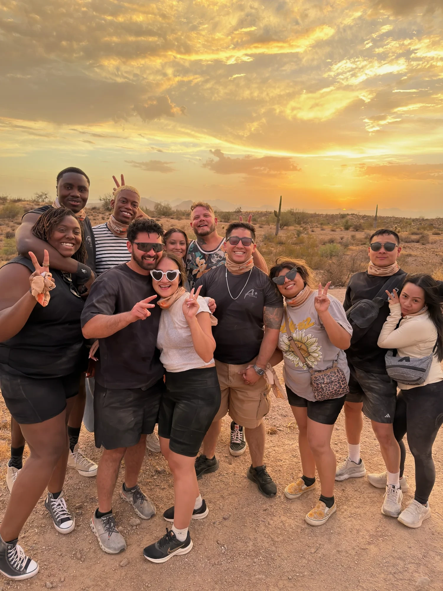 Happy riders throwing peace signs at sunset in the Scottsdale desert